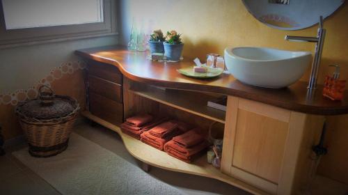 a bathroom with a sink and a counter with towels at B&B Fiadora Artist House in Decimoputzu