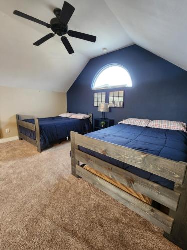 a bedroom with two beds and a ceiling fan at Enjoy Our Ocean Oasis in Galveston