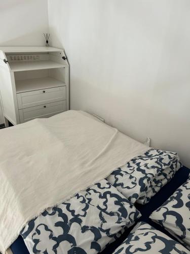 a small bedroom with a bed and a dresser at Apartament Wspólna in Sosnowiec