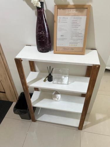 a vase sitting on a shelf next to a box at Condo Beside Abreeza Ayala Mall in Davao City