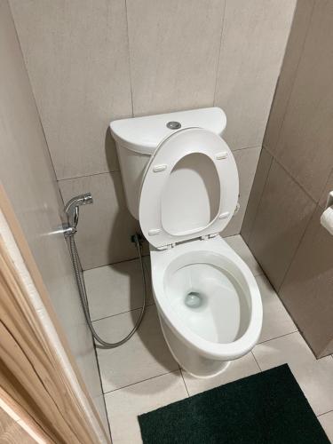 a bathroom with a toilet in a stall at Condo Beside Abreeza Ayala Mall in Davao City
