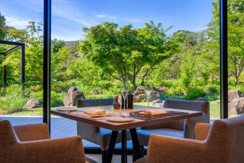 a dining room with a table and a large window at Hotel Okura Kyoto Okazaki Bettei -Age Requirement 12 over- in Kyoto