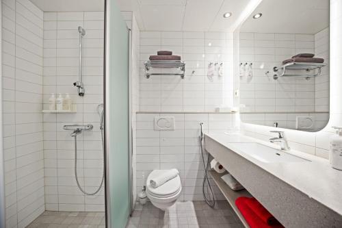 a bathroom with a toilet and a sink and a shower at Original Sokos Hotel Vaakuna Mikkeli in Mikkeli