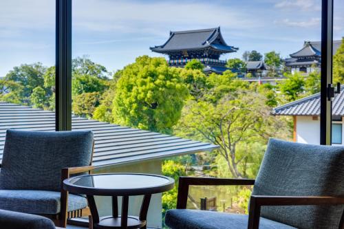 a room with two chairs and a table and a window at Hotel Okura Kyoto Okazaki Bettei -Age Requirement 12 over- in Kyoto