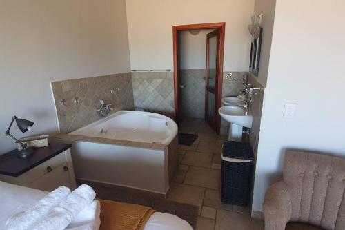 a bathroom with a tub and a sink and a toilet at Sunset View 10 @ Langstrand in Langstrand