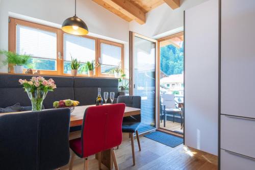 a kitchen and dining room with a table and chairs at Ferienwohnung Kirchmair in Kirchdorf in Tirol