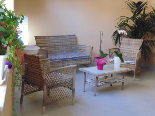 a living room with wicker chairs and a table with at Residence Le Isole in Marsala
