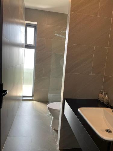 a bathroom with a white toilet and a sink at SEN VILLA Boutique in Bao Loc