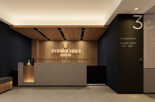 a lobby with a reception desk with a skull on the wall at FIERIS IZZY Hotel in Jakarta