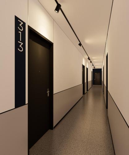 a hallway of an office building with a sign on the wall at FIERIS IZZY Hotel in Jakarta