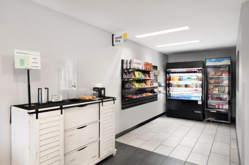 a kitchen with two refrigerators and a refrigerator at Garner Hotel Auburn - Seattle by IHG in Auburn