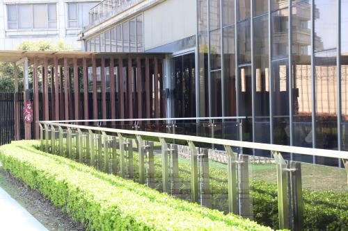 a fence in front of a glass building at Crowne Plaza Shanghai Anting-Auto City - 15 Minutes drive to F1 in Jiading