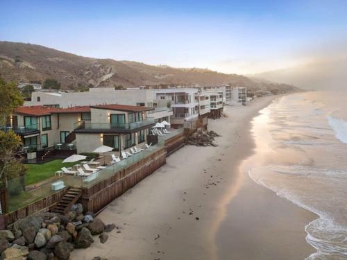 an aerial view of a beach with houses and the ocean at Malibu Sand Carbon Beach Suites in Malibu