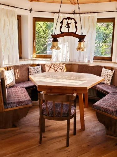 a dining room with a wooden table and chairs at Chalet Anna in Unterwössen