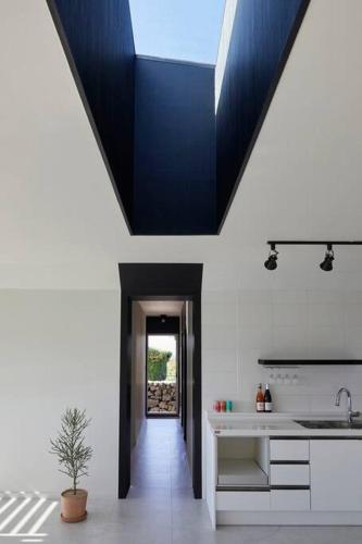 a kitchen with a blue ceiling with a sink at Sunyeonchae in Jeju