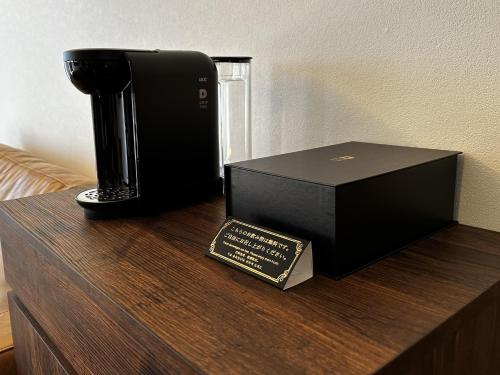 a black box and a book on a wooden table at Hotel Dios - Vacation STAY 31184v in Awaji
