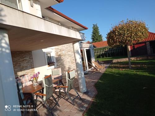 a patio with chairs and a table in a yard at Haloze ForMe in Zavrč