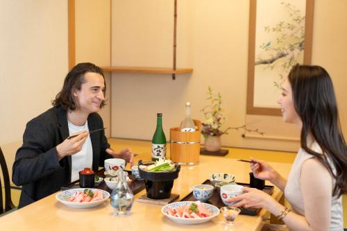 two women sitting at a table eating food at Hotel Associa Toyohashi in Toyohashi