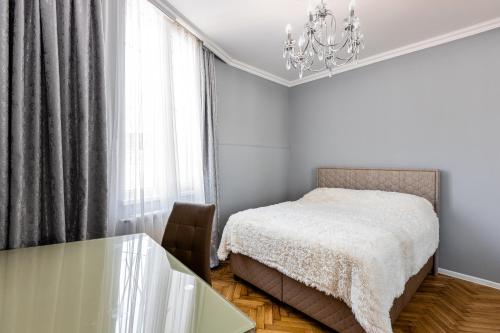 a bedroom with a bed and a glass table at MaRKoS Sololaki Flat in Tbilisi City