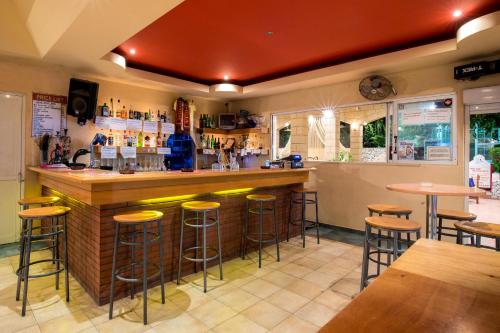 a bar in a restaurant with bar stools at Saint Amon Hotel in Faliraki