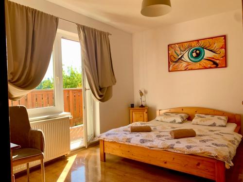 a bedroom with a bed and a large window at Pension Aqualand in Poprad