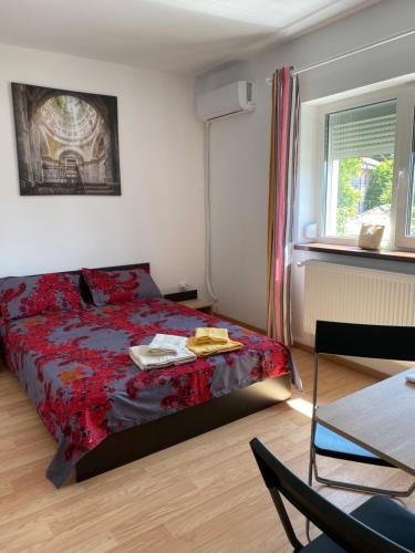 a bedroom with a bed and a chair and a window at Casa Blanca in Techirghiol