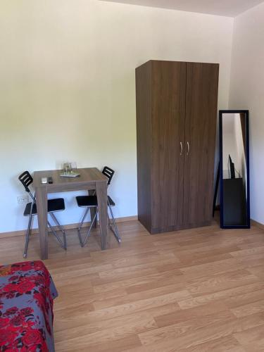 a room with a table and a wooden cabinet at Casa Blanca in Techirghiol