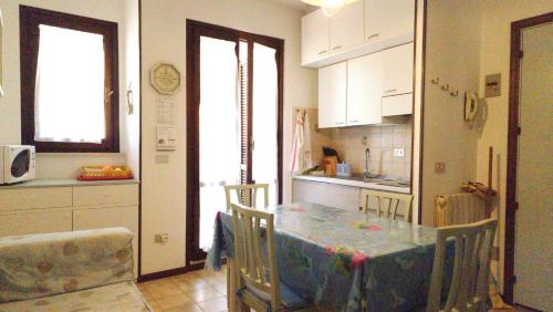 a kitchen with a table and chairs and a kitchen with a counter at Conero 33 Primo Piano Casa Vacanze in Numana
