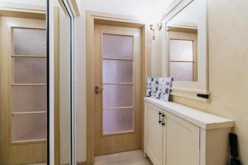 a bathroom with a sink and a mirror at Elegant 1-Bedroom Apartment in Plovdiv