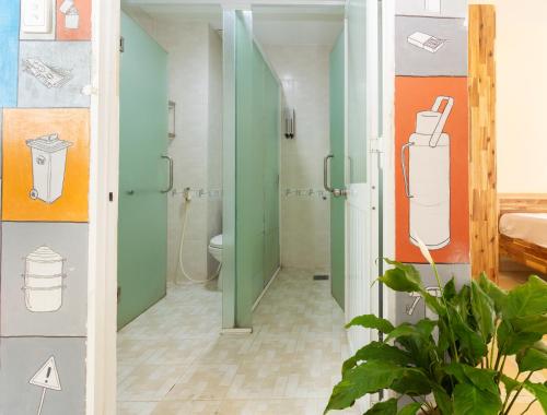 a bathroom with a shower stall and a toilet at Ehome Saigon - Gạo hostel in Ho Chi Minh City