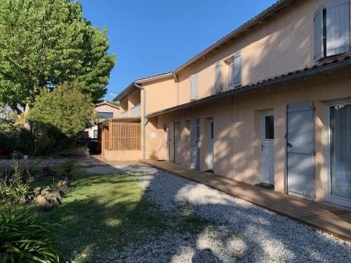 a house with a driveway in front of it at LOGIS HOTELS - Hôtel et Restaurant L'Océana in Lanton