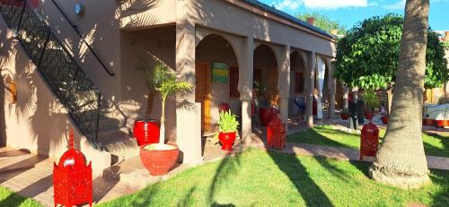 a group of red fire hydrants in front of a building at Jenny Lynn in Marrakech