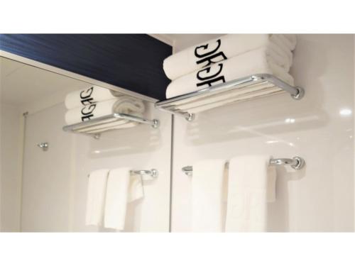 a mirror in a bathroom with towels at Green Rich Hotel Okinawa Nago - Vacation STAY 49905v in Nago