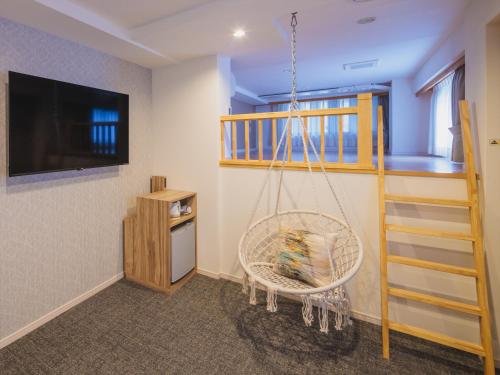 a room with a hanging chair and a staircase at Giappo Franca Kyoto in Kyoto