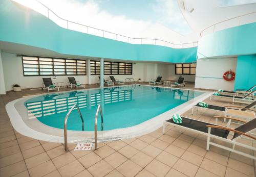 a large swimming pool in a large building at Holiday Inn Abu Dhabi, an IHG Hotel in Abu Dhabi