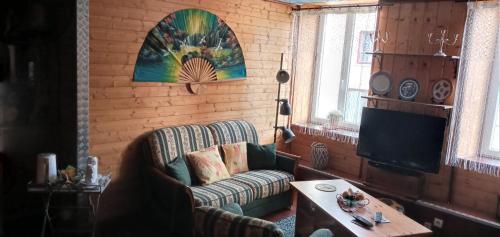 a living room with a couch and a table at Le Relais De Rochepaule in Rochepaule