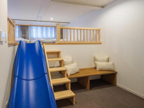 a room with a bunk bed and a blue slide at Giappo Franca Kyoto in Kyoto