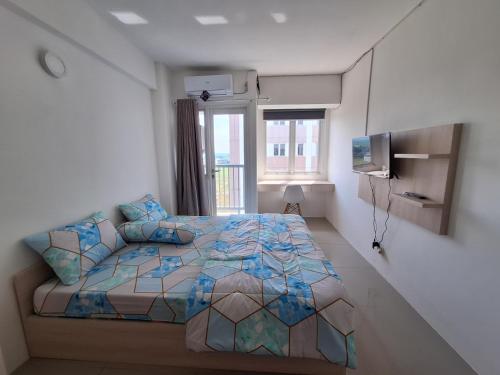 um quarto com uma cama e uma janela em Grand Sentraland Karawang by DnA Rooms em Karawang