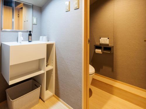 a bathroom with a toilet and a sink at Giappo Franca Kyoto in Kyoto