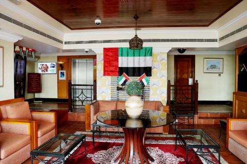 a living room with a couch and a table at City Plaza Hotel in Fujairah