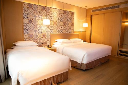 Postel nebo postele na pokoji v ubytování Wyndham Grand Plaza Royale Yuzhou Xiamen Wuyuan Bay
