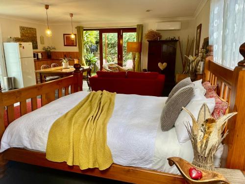 a bedroom with a bed with a yellow blanket on it at The Red Barn right in the heart of historic Berry in Berry