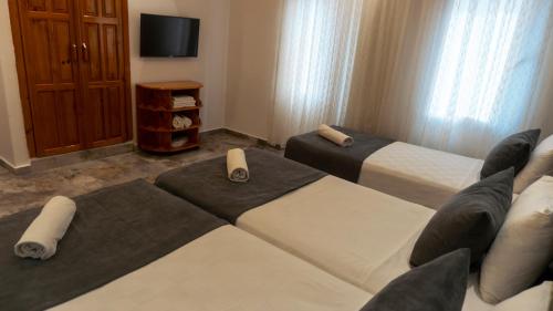 a hotel room with two beds and a couch at Rain Hotel in Kizkalesi