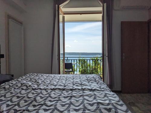 a bedroom with a bed and a view of the ocean at Appa Apartments in Portorož