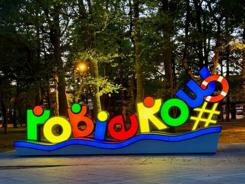 a sign that says roberto in a park at Leśna Przystań in Pobierowo