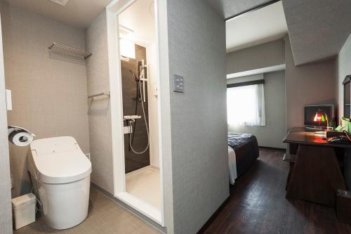 a bathroom with a toilet and a shower in it at Okazaki Ohwa Hotel in Okazaki