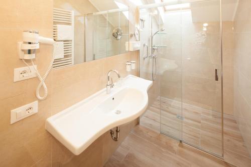 a bathroom with a sink and a shower at Residence Preyhof in Caldaro