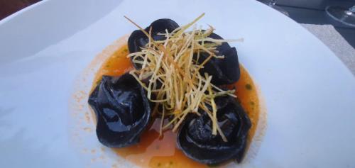 a plate of food with black olives and cheese at Stephanie Residence - in the heart of Alps above Varenna, Lake Como in Esino Lario