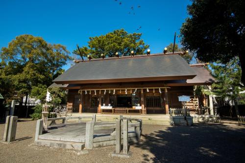 a building with a fence in front of it at Hotel Associa Toyohashi in Toyohashi