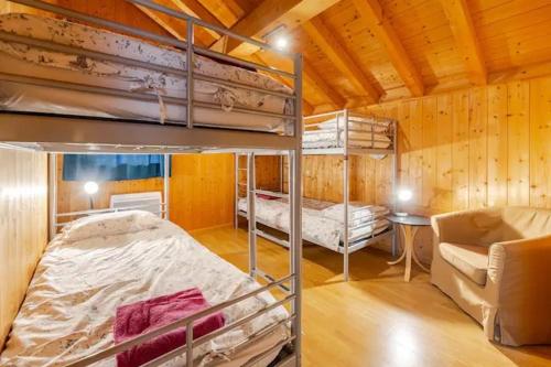 a room with two bunk beds and a couch at Chalet Etoile in Saint-Jean-d'Aulps
